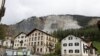 FILE - Residential buildings stand in front of the Brienzer Rutsch, the rockfall danger zone in Brienz-Brinzauls, Switzerland, May 12, 2023. 