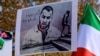 FILE - A placard bears the portrait of Iranian rapper Toomaj Salehi during a rally in Istanbul, Turkey, Nov. 26, 2022. Salehi was jailed in Iran for supporting protests there, but the Iranian Supreme Court has overturned his death sentence, Salehi's lawyer said on June 22, 2024.