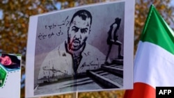 FILE - A placard bears the portrait of Iranian rapper Toomaj Salehi during a rally in Istanbul, Turkey, Nov. 26, 2022. Salehi was jailed in Iran for supporting protests there, but the Iranian Supreme Court has overturned his death sentence, Salehi's lawyer said on June 22, 2024.