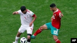 Masoud Shojaei, à gauche, et Younes Belhanda, à droite, lors du match entre le Maroc et l'Iran, Russie, le 15 juin 2018