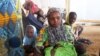 FILE - A family of refugees that fled their homes due to violence from the Islamic extremist group Boko Haram sit inside a refugee camp in Minawao, Cameroon, Feb. 25, 2015.