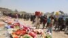 Displaced civilians from Ramadi wait to receive humanitarian aid from the United Nations in a camp in the town of Amiriyat al-Fallujah, west of Baghdad, Iraq, May 22, 2015. 