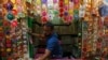 A man arranges "Rakhis" or sacred threads as he waits for customers at his roadside stall ahead of the Hindu festival Raksha Bandhan celebrations, in Kolkata, India.