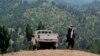 FILE - A Taliban militant is seen walking in Pakistan's tribal region of North Waziristan. Aug. 12, 2013. 