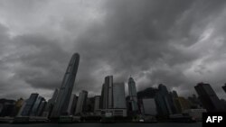 FILE - Heavy rain clouds are seen over Hong Kong on Oct. 8, 2023, as typhoon Koinu skirted by. The stock exchange will continue trading during heavy storms, the city's leader announced. 
