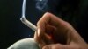 FILE - A woman smokes a cigarette. 