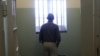 U.S. President Barack Obama stands in the Robben Island prison cell that Nelson Mandela spent 18 of his 27 years of imprisonment near Capetown, June 30, 2013. 