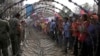 Cambodian garment workers, right, are blocked by barbed wire set up by police near the Council of Ministers building during a rally in Phnom Penh, Cambodia, Monday, Dec. 30, 2013. 