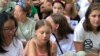 Young climate activist Greta Thunberg, center, listens during a rally outside the United Nations in New York to demand action on global warming, Aug. 30, 2019. (M. Besheer/VOA)