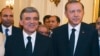 In this Aug. 12, 2014 photo, released by Turkish officials, Turkish President Abdullah Gul, left, and president-elect Recep Tayyip Erdogan stand pose for photos during a farewell reception for Gul in Ankara, Turkey.