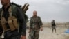 FILE - Kurdish Peshmerga fighters search for Islamic State militants in Telskuf, northern Iraq, May 4, 2016.