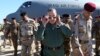 Iraqi Defense Minister Khaled al-Obeidi, center, arrives at a military a base outside Tikrit, 130 kilometers (80 miles) north of Baghdad, Iraq, March 9, 2016. 
