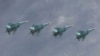 FILE - Sukhoi Su-34 Fullback tactical bombers fly in formation over the Red Square during the Victory Day parade in Moscow, Russia, May 9, 2015.