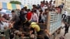 Cambodian migrant workers get off from a Thai truck upon their arrival from Thailand at a Cambodia-Thai international border gate in Poipet, Cambodia, Tuesday, June 17, 2014. The number of Cambodians who have returned home from Thailand this month after a threatened crackdown on foreigners working illegally has topped 160,000, a Cambodian official said. 