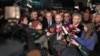 Can Dundar, the editor-in-chief of opposition newspaper Cumhuriyet, center right, and Erdem Gul, the paper's Ankara representative, center left, speak to the media outside Silivri prison near Istanbul, after their release early Friday, Feb. 26, 2016.