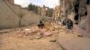 FILE - People walk amid the wreckage of damaged buildings in a street hit by shelling in Aleppo, Syria.