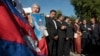 A supporter of the opposition Cambodia National Rescue Party holds a poster of the party leader Kem Sokha during a rally joined by lawmakers near an appeals court in Phnom Penh, Cambodia, Tuesday, Sept. 26, 2017. The court rejected a request for the release on bail of opposition leader Kem Sokha, who has been charged with treason in a case that is seen as a partisan political effort by the government ahead of next year's general election. (AP Photo/Heng Sinith)