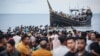 Newly arrived Rohingya refugees return to a boat after the local community decided to temporarily allow them to land for water and food in Ulee Madon, Aceh province, Indonesia, on Nov. 16, 2023.