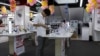 FILE - A customer look at a mobile phone on display at an electronics market in Shanghai, China.