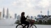 A woman rides a bicycle at a park, amid the coronavirus disease (COVID-19) pandemic, in Kuala Lumpur, Malaysia, Sept. 27, 2021. 