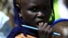 FILE - A girl waits to receive food provided by the United Nations' World Food Programme at a camp for internally displaced persons in Azaza, east of Ad Damazin, capital of Blue Nile state in Sudan, Oct. 21, 2015.