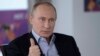 Russian President Vladimir Putin answers a journalist's question during a televised news conference in Sochi, Jan. 19, 2014. 