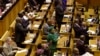 Members of the ruling African National Congress applaud as the results are read of a no-confidence vote by MP's in parliament in Cape Town South Africa, Aug. 8, 2017.