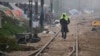 A migrant man walks on railway tracks with a towel on his head at the northern Greek border point of Idomeni, Greece, March 18, 2016.