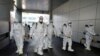 Workers from a disinfection service company sanitize a branch of the Shincheonji Church of Jesus the Temple of the Tabernacle of the Testimony where a woman known as "Patient 31" attended a service in Daegu, South Korea, February 19, 2020. Yonhap…