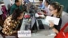 FILE PHOTO - Locals sit for registering their names during a voter registration process of the National Election Committee (NEC) in Phnom Penh, Cambodia, Thursday, Sept. 1, 2016. 