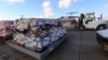 FILE - Workers load humanitarian aid from the United Nations onto a plane for Syrian families in Arbil airport, about 220 miles north of Baghdad, Dec. 15, 2013. A key Syrian adviser criticized such aid Thursday.