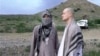 In this image taken from video obtained from Voice Of Jihad Website, which has been authenticated based on its contents and other AP reporting, Sgt. Bowe Bergdahl, right, stands with a Taliban fighter in eastern Afghanistan. 