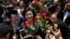 FILE PHOTO - Thailand's former Prime Minister Yingluck Shinawatra, center, receives flowers from her supporters at the Supreme Court after making her final statements in a trial on a charge of criminal negligence in Bangkok, Thailand, Tuesday, Aug. 1, 2017. 