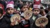 Palestinian children hold bread patties during a protest against aid cuts, outside the United Nations' offices in Khan Yunis in the southern Gaza Strip on Jan. 28, 2018.
