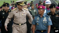 Chief of Thai Defense Force Gen. Thanasak Patimaprakorn, left, walks with Indonesian Marine Chief of Staff Brig. Gen Achmad Faridz during his visit at the marine headquarters in Jakarta, Indonesia, July 18, 2012.
