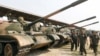 Cambodia's Deputy Prime Minister and Defence Minister Tea Banh (2nd R) inspects tanks inside the Army Institute after a graduation ceremony at Army Institute in Kampong Speu province March 12, 2015. 
