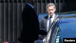 Former French President Nicolas Sarkozy leaves his residence in Paris, July 2, 2014.