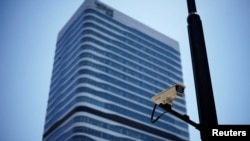 A surveillance camera is seen in front of an office building, where the office of Capvision is located, in Shanghai