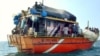 Sri Lankans asylum seekers stay on their traditional boat near Dili's port, July 31, 2002.
