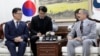 South Korean Unification Minister Kim Yeon Chul, left, meets with U.S. Ambassador to South Korea Harry Harris, right, during their meeting at a government complex in downtown Seoul, South Korea, Tuesday, April 16, 2019. (AP Photo/Lee Jin-man)