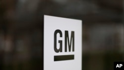 FILE - The General Motors logo at the company's world headquarters in Detroit.