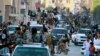 FILE - Fighters from the Islamic State group parade in Raqqa, north Syria, June 30, 2014. A former British spy chief said at the time that militants had more than doubled the recruitment of foreign fighters to as much as 31,000 over an 18-month period.