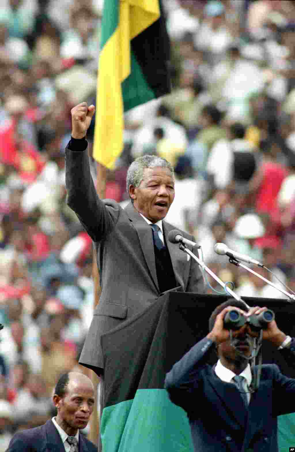Nelson Mandela, is seen as he gives the black power salute to 120,000 ANC supporters in Soweto's Soccer City stadium, Feb. 13, 1990.