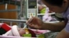 Two-hour old daughter of 17-year old Nakor is fed by a nurse at a hospital in Chiang Mai's Fang district October 2, 2012. 