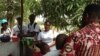 FILE - Zero Ebola Campaign volunteers talk to residents in Freetown, Sierra Leone, March 27, 2015. ( Nina deVries/VOA)