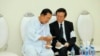 Cambodian Prime Minister Hun Sen, left, talks with dissolved main opposition Cambodia National Rescue Party leader Kem Sokha at the mourning ceremony of Sen's mother in-law, in Phnom Penh, Cambodia, Tuesday, May 5, 2020. (Pool via AP) 