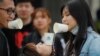 People play games as they gather for a barbecue at a scenic area in Fangshan district in Beijing, Monday, May 4, 2020, after authorities loosened up nationwide restrictions following months of lockdown over the coronavirus outbreak. (AP Photo/Andy…