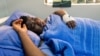 FILE - Activist Joana Mamombe lies hospitalized in Harare on May 15, 2020. after allegedly being abducted and beaten by police and eventually dumped along the roadside some distance from the capital.
