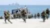 FILE - In this May 9, 2018 photo, Philippine and U.S. Marines storm a beach as part of an amphibious landing exercise during a two-week joint U.S.-Philippines exercise facing the South China Sea in the Philippines. 