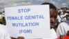 FILE - Masai girl holds protest sign during anti-Female Genital Mutilation (FGM) run in Kilgoris, Kenya.